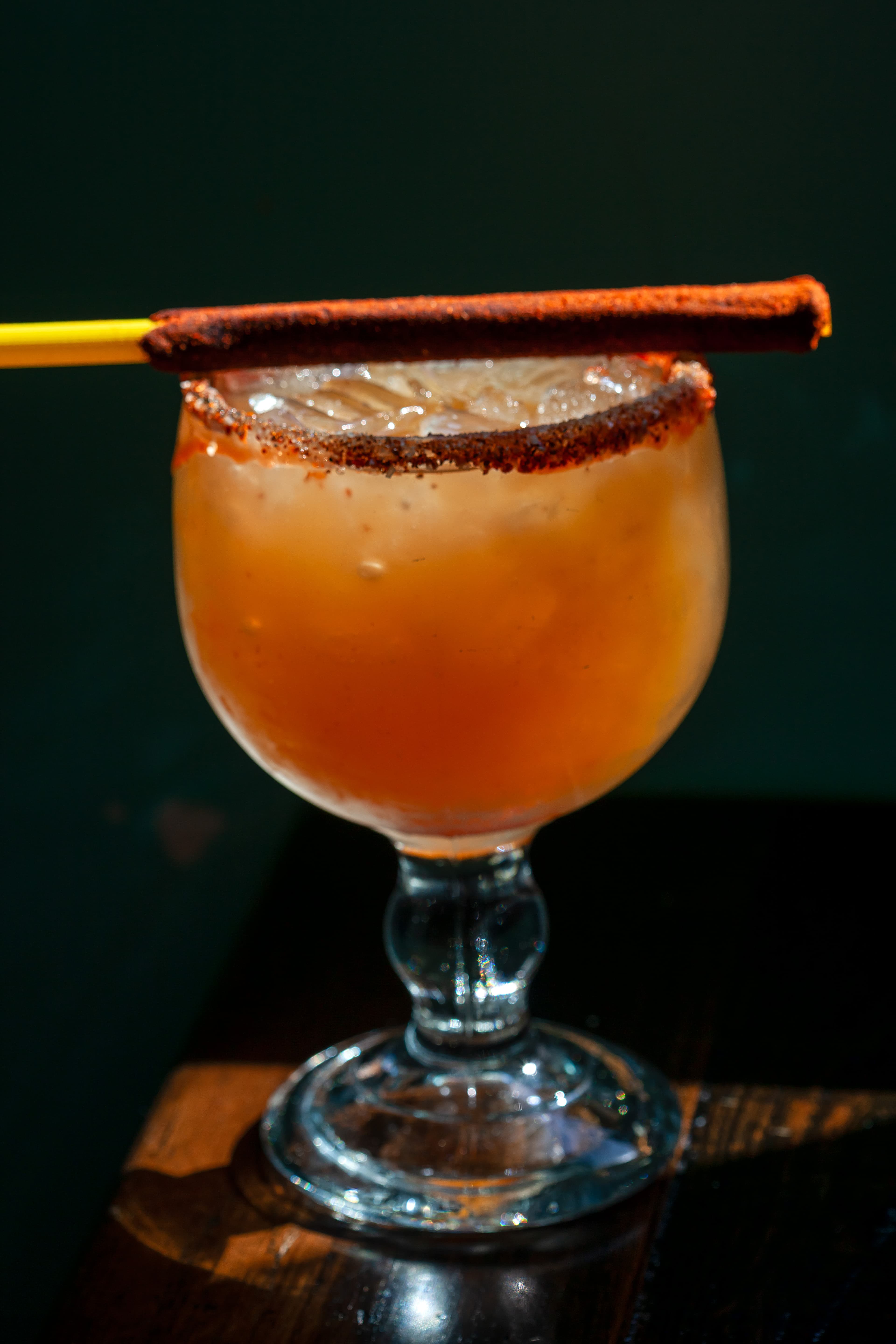 Fishbowl cocktail with tamarind stick