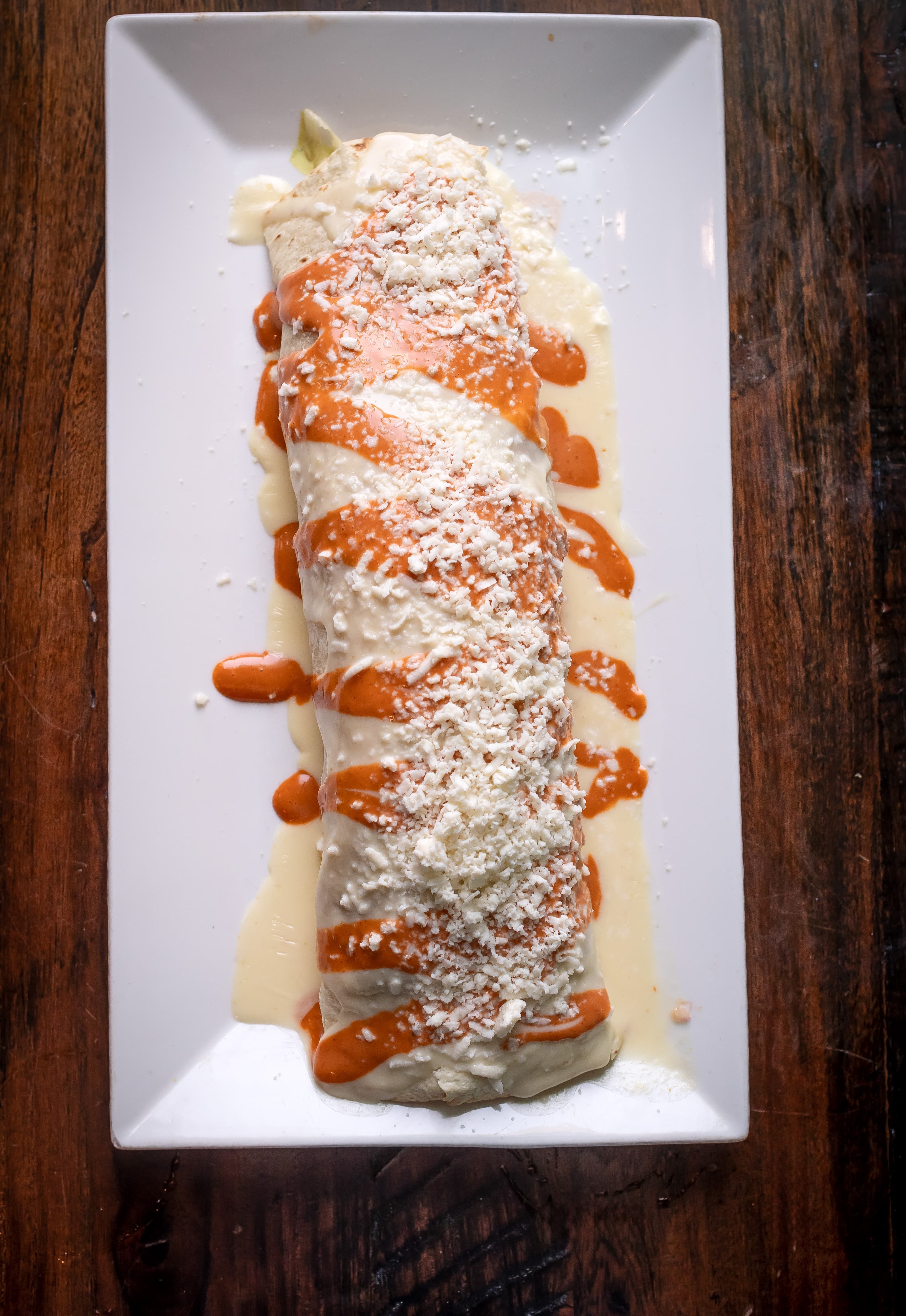 Bulldog Burrito with chipotle sauce and queso